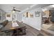 Bright dining area featuring a large wooden table, modern fixtures and an open transition to the kitchen at 10303 Se Sunset Harbor Rd, Summerfield, FL 34491