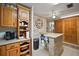 Well-organized kitchen with ample cabinet space, brick accents, and functional layout for cooking at 10303 Se Sunset Harbor Rd, Summerfield, FL 34491