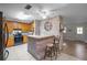 Kitchen with oak cabinets, brick breakfast bar, stainless steel appliances, and ceiling fan at 10303 Se Sunset Harbor Rd, Summerfield, FL 34491