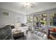 Living room with sliding glass doors to a patio with outdoor seating at 10303 Se Sunset Harbor Rd, Summerfield, FL 34491