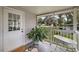 Cozy porch with views of the well maintained backyard, featuring a unique decorative bathtub at 10303 Se Sunset Harbor Rd, Summerfield, FL 34491