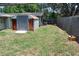 View of backyard with shed, grass, and wooden fence at 1095 Golden Isle Dr, Mount Dora, FL 32757