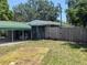 View of a backyard with a carport and wooden fence at 1095 Golden Isle Dr, Mount Dora, FL 32757