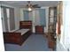 Bedroom with blue carpet, a ceiling fan, and an abundance of natural light at 1095 Golden Isle Dr, Mount Dora, FL 32757