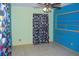 Bright bedroom with tile flooring, colorful walls, and natural light at 1095 Golden Isle Dr, Mount Dora, FL 32757