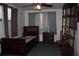 Bedroom with ceiling fan, dresser, and dark wood furniture set at 1095 Golden Isle Dr, Mount Dora, FL 32757