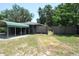 View of the carport and backyard showcasing a wooden fence and ample outdoor space at 1095 Golden Isle Dr, Mount Dora, FL 32757