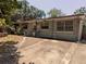 Exterior view of home featuring a covered porch, concrete driveway, and mature trees at 1095 Golden Isle Dr, Mount Dora, FL 32757