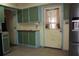 Kitchen with tile flooring and view of back door with kitchen cabinets at 1095 Golden Isle Dr, Mount Dora, FL 32757