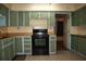 Traditional kitchen with vintage green cabinets, offering a unique and nostalgic charm at 1095 Golden Isle Dr, Mount Dora, FL 32757