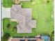 Overhead view showcasing house, green lawn, roof details, and landscaping at 11019 Se 170Th Lane Rd, Summerfield, FL 34491