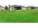 Expansive backyard features lush green lawn, perfect for recreation and outdoor activities at 11019 Se 170Th Lane Rd, Summerfield, FL 34491