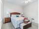 Cozy bedroom with a classic wooden bed frame, complemented by soft colors and ample natural light at 11019 Se 170Th Lane Rd, Summerfield, FL 34491