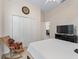 Bedroom featuring a bed, rocking chair, closet, and a view into the dining room, offering convenience and style at 11019 Se 170Th Lane Rd, Summerfield, FL 34491