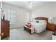 A serene bedroom with a plush bed, soft lighting, and a classic dresser for a relaxing retreat at 11019 Se 170Th Lane Rd, Summerfield, FL 34491