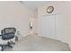 Bedroom featuring neutral carpet, closet, and decor, creating a serene and inviting atmosphere at 11019 Se 170Th Lane Rd, Summerfield, FL 34491