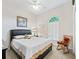 Bedroom featuring a black leather headboard bed, rocking chair, and a window with an arched top at 11019 Se 170Th Lane Rd, Summerfield, FL 34491