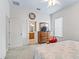 Spacious bedroom featuring a view into the en-suite bathroom, a dresser with a TV, and neutral decor at 11019 Se 170Th Lane Rd, Summerfield, FL 34491
