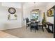 The dining area features a chandelier, large windows, and neutral colors at 11019 Se 170Th Lane Rd, Summerfield, FL 34491