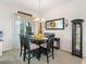 An inviting dining room features a round table and stylish decor, perfect for Gathering meals and entertaining at 11019 Se 170Th Lane Rd, Summerfield, FL 34491