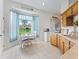 Bright kitchen nook with a breakfast table set, surrounded by windows and featuring traditional wood cabinetry at 11019 Se 170Th Lane Rd, Summerfield, FL 34491