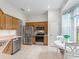 A well-lit kitchen has stainless steel appliances, ample cabinets, and a cozy breakfast nook by the window at 11019 Se 170Th Lane Rd, Summerfield, FL 34491