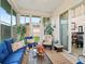 Relaxing sunroom with bright windows, comfortable seating, and a view of the outdoors, perfect for leisure at 11019 Se 170Th Lane Rd, Summerfield, FL 34491