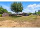 Spacious backyard with sheds, storage areas, and a lawn ready for landscaping at 1119 Pine Ave, Tavares, FL 32778
