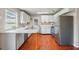 Well-lit kitchen featuring stainless steel appliances and ample white cabinetry at 1119 Pine Ave, Tavares, FL 32778