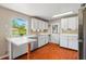 Spacious kitchen with white cabinets, stainless appliances, and bright natural lighting at 1119 Pine Ave, Tavares, FL 32778