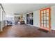 Covered patio with furniture, sliding glass doors, and an orange exit door at 1119 Pine Ave, Tavares, FL 32778