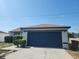 Charming single-story home with blue garage door, landscaped front, and bright blue skies at 112 Arlington Ct, Haines City, FL 33844