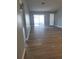 A spacious living room with vinyl floors, neutral-colored walls, and sliding glass door to the patio at 112 Arlington Ct, Haines City, FL 33844