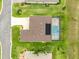 A bird's-eye perspective of a home featuring a private pool within a screened enclosure, capturing an elegant outdoor living space at 11215 Se 172Nd Place, Summerfield, FL 34491