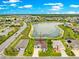 An aerial view of a beautiful single-story home nestled in a tranquil neighborhood near a scenic pond at 11215 Se 172Nd Place, Summerfield, FL 34491