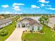 A picturesque aerial view of a single-story home, set against a serene pond and lush surroundings at 11215 Se 172Nd Place, Summerfield, FL 34491