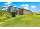 The backyard shows a screened enclosure with a covered patio and green grass at 11215 Se 172Nd Place, Summerfield, FL 34491