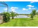 Expansive backyard with lush green lawn and scenic views of the serene lake at 11215 Se 172Nd Place, Summerfield, FL 34491
