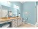 Bright bathroom features a vanity with granite counters, stylish lighting and tile floors at 11215 Se 172Nd Place, Summerfield, FL 34491