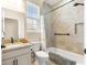 Tiled bathroom featuring a shower-tub combo, granite vanity, and a window for natural light at 11215 Se 172Nd Place, Summerfield, FL 34491