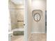 Neutral bathroom with tub-shower, tiled walls, alcove, vanity and mirror at 11215 Se 172Nd Place, Summerfield, FL 34491