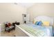 Comfortable bedroom with white furnishings, plush bedding, and a window for ample light at 11215 Se 172Nd Place, Summerfield, FL 34491