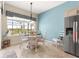 Bright dining area with a round table, white chairs, and a large window offering a pleasant view at 11215 Se 172Nd Place, Summerfield, FL 34491