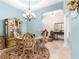 Elegant dining room features a chandelier, decorative cabinet, and tile floors at 11215 Se 172Nd Place, Summerfield, FL 34491