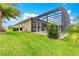 Exterior view of the property with a well-maintained lawn and lush landscaping at 11215 Se 172Nd Place, Summerfield, FL 34491