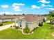 Aerial view of a well-maintained single-story home, showcasing its backyard, lawn, and landscaping at 11215 Se 172Nd Place, Summerfield, FL 34491