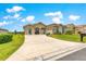 Charming single-story home with a well-manicured lawn and a long driveway leading to a two-car garage at 11215 Se 172Nd Place, Summerfield, FL 34491