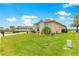 Charming single-Gathering home with a well-manicured lawn and tropical landscaping at 11215 Se 172Nd Place, Summerfield, FL 34491