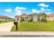 Well-maintained single Gathering home with a green lawn and beautiful landscaping at 11215 Se 172Nd Place, Summerfield, FL 34491
