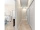 Neutral hallway with tiled floor leading to multiple rooms, with several closet doors for ample storage at 11215 Se 172Nd Place, Summerfield, FL 34491